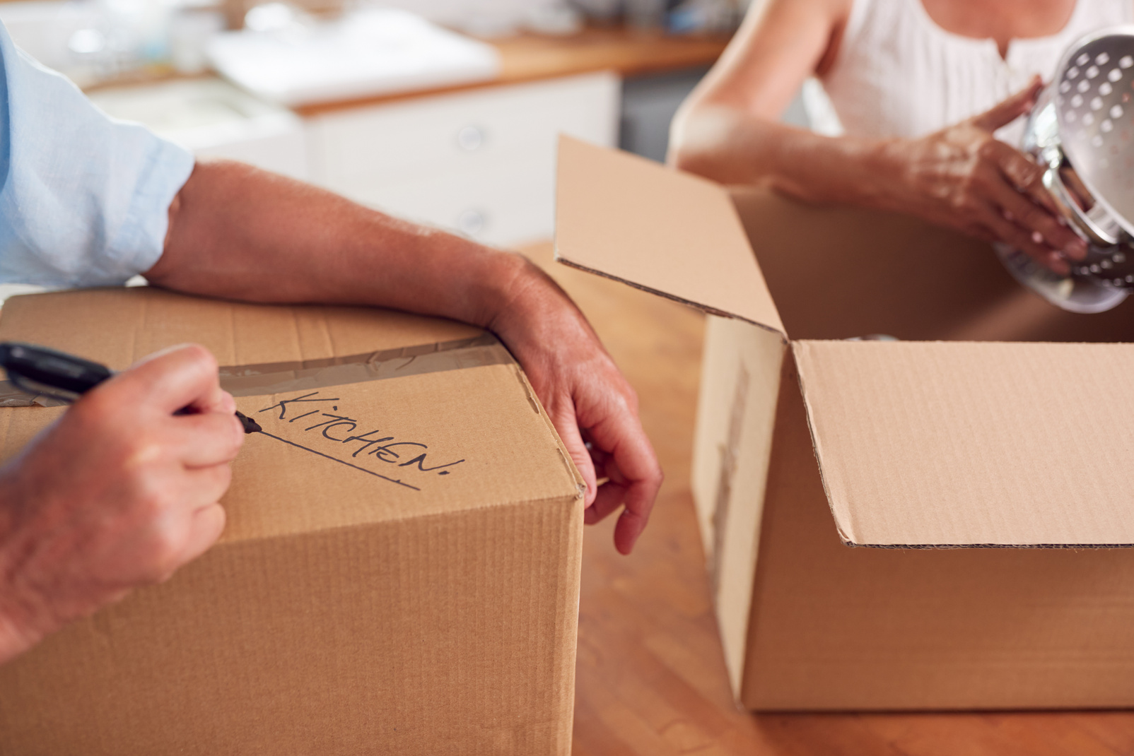 Close up of Senior Couple Downsizing in Retirement Boxes Ready F